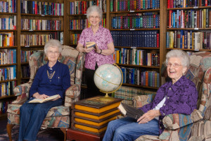 A group of elderly women in an assisted living's residence library
